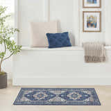Bright entryway with Nourison Fulton Navy Ivory rug, plant, pillows, and art. Vintage style.