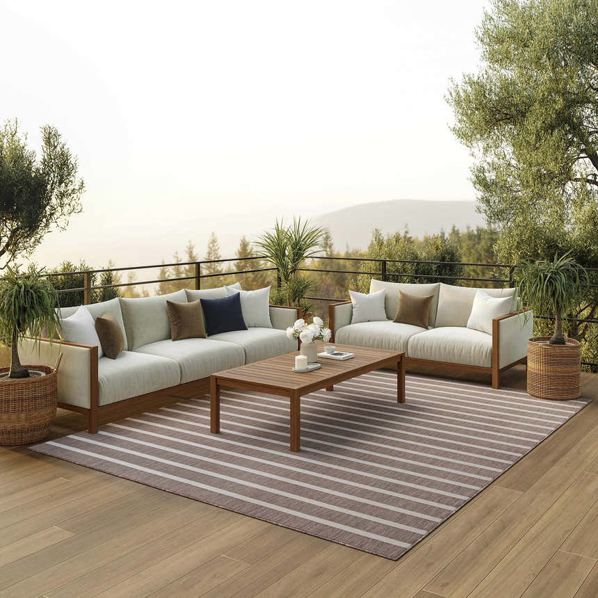 Outdoor living space with white sofas and Nourison Positano Natural Ivory rug with chestnut stripes.