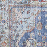 Close up of the Nourison Fulton Blue Vintage Indoor Area Rug, featuring floral and geometric patterns.
