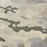 Close-up of the Nourison Prismatic Silver Cloud Rug. Abstract design in silver, cloud, and neutral tones. Soft, textured wool blend.