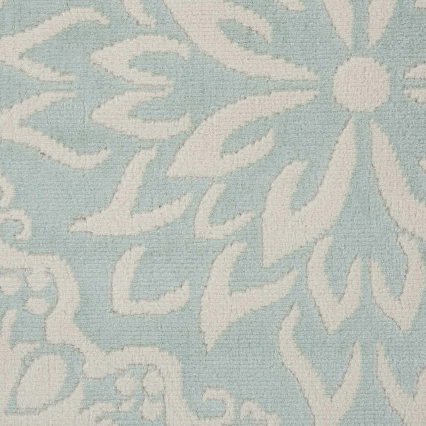 Close-up of Nourison Jubilant Ivory Green rug showing floral pattern and texture.