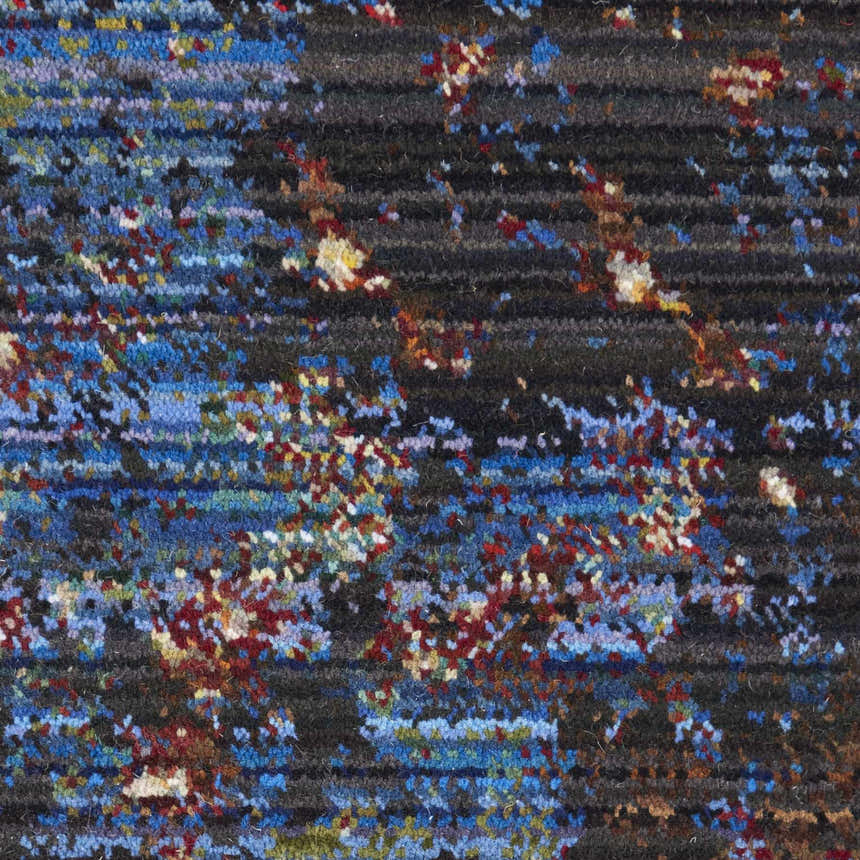 Close-up of the Nourison Chroma Red Flare rug, featuring an abstract pattern with red, blue, and neutral tones.