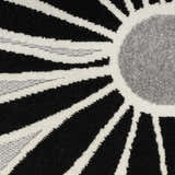 Close-up of the Nourison Aloha Black White Outdoor Area Rug featuring a geometric sunburst pattern.