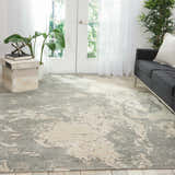 Bright living room with a gray sofa and Nourison Silk Shadows Sand area rug.