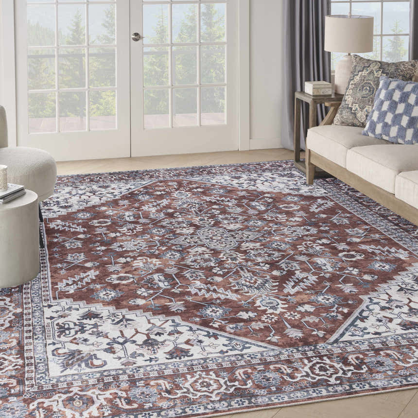 Living room scene with brick-colored Nourison New Concept rug, ivory sofa, and natural light. Vintage style.