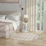 Farmhouse bedroom scene with a round Nourison Grafix Ivory Beige area rug, light wood floors, and neutral bedding.