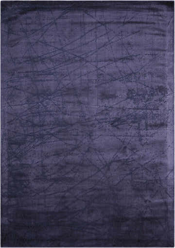 Close-up of the Calvin Klein Home Maya Orchid rug. Purple with subtle, abstract line pattern. Handmade.