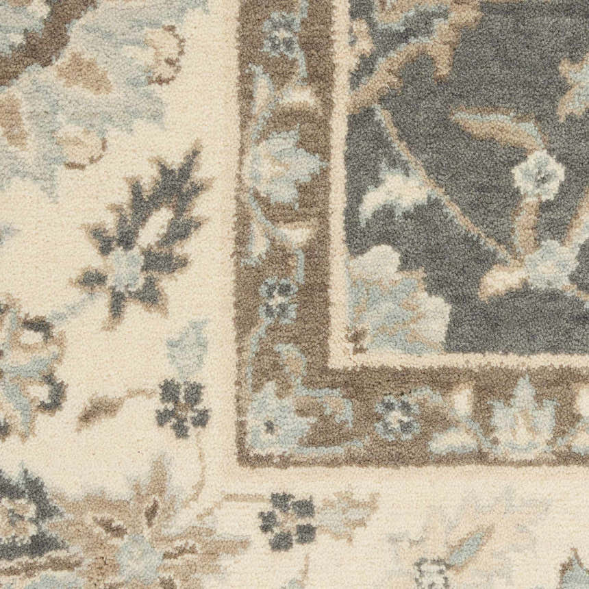 Close-up of Nourison Living Treasures rug. Farmhouse style with grey, ivory, chestnut floral pattern and border. Wool texture.