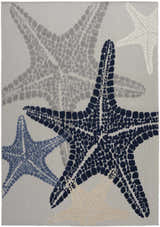 Close-up of Nourison Aloha Grey Multicolor rug featuring starfish in navy, grey, blue, and beige. Coastal style.