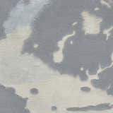 Close-up of the Nourison Prismatic Seafoam Silver Rug, showcasing its abstract seafoam and silver pattern and soft, textured wool blend.