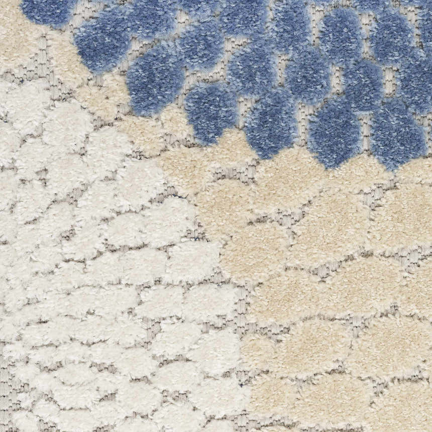 Close-up of the Nourison Aloha Blue Grey Modern Area Rug showing its textured blue, gray, and cream geometric pattern.