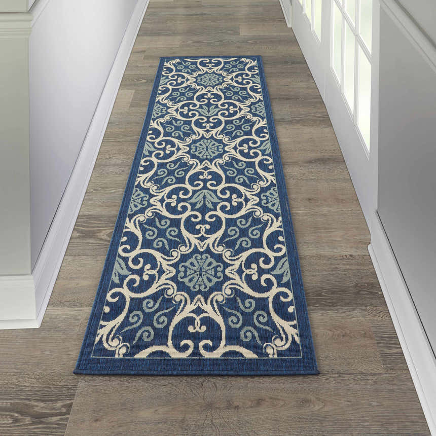 Hallway with a Nourison Caribbean Navy Contemporary Area Rug runner on wood floor.