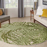 Living room scene with a round Nourison Aloha Ivory Green Outdoor Area Rug.