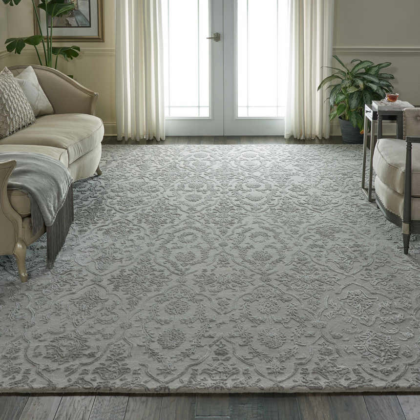 Living room scene with a Nourison Opaline Taupe Vintage rug, ivory sofa, hardwood floors, and natural light.