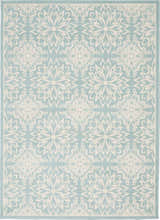 Close-up of the Nourison Jubilant Ivory Green rug, showcasing its floral farmhouse pattern and soft texture.