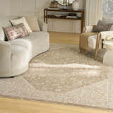 Living room scene with a light brown Nourison Retreat Mocha Vintage Indoor Area Rug, sofa, and chair.