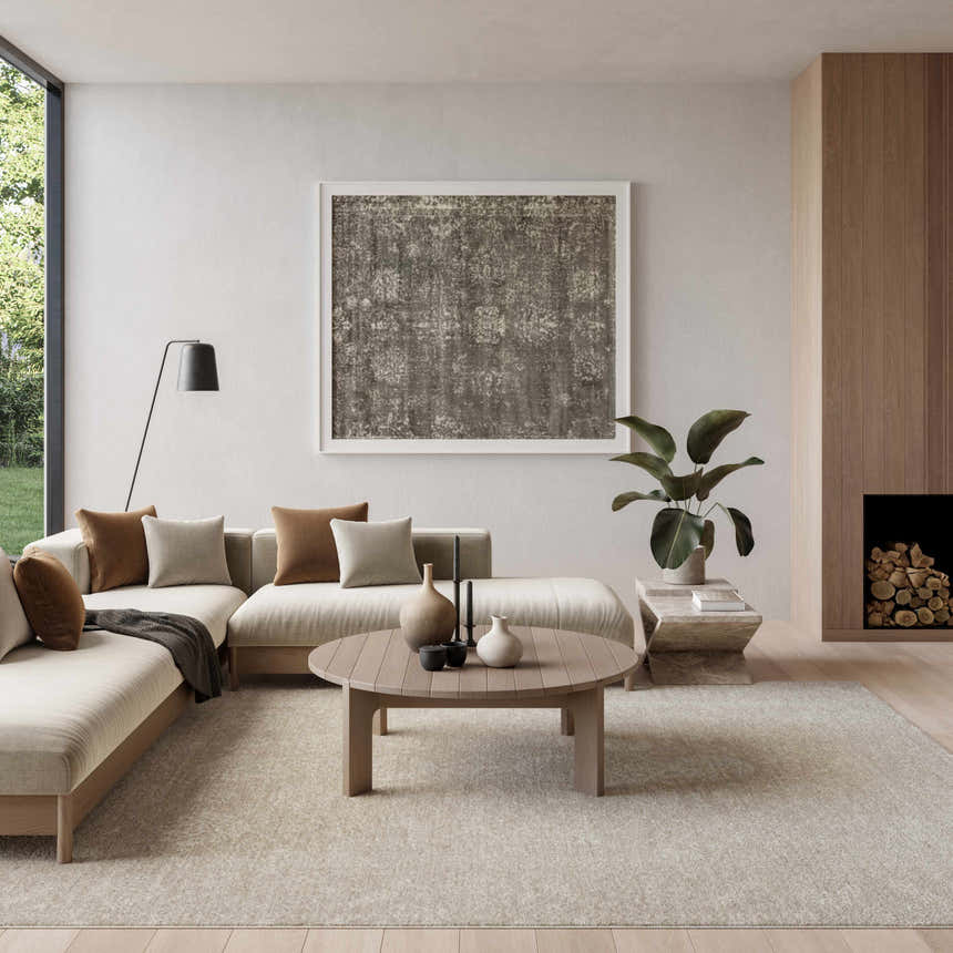 Modern living room with a beige sectional, wood accents, and Nourison Moonlit Ivory Grey Vintage Indoor Area Rug.