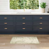 Kitchen scene with blue cabinets and Nourison Aloha Ivory Sage rug on wood floor.