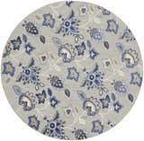 Close-up of a round Nourison Aloha Blue Grey Outdoor Area Rug with a blue and taupe floral pattern on a gray background.