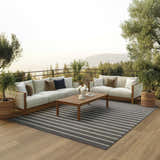 Outdoor patio with sofas and Nourison Positano Charcoal Ivory rug. Striped rug adds modern style to the outdoor living space.