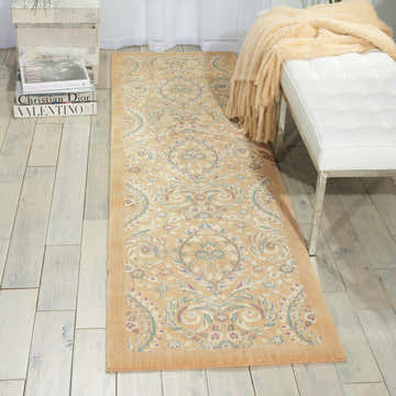 Entryway scene with Barclay Butera Hinsdale Lily runner rug, light wood floors, and white bench with a cozy throw.