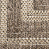 Close-up of Nourison Tulum Brown Outdoor Area Rug showing texture and pattern. Dark brown pile with light tan accents.