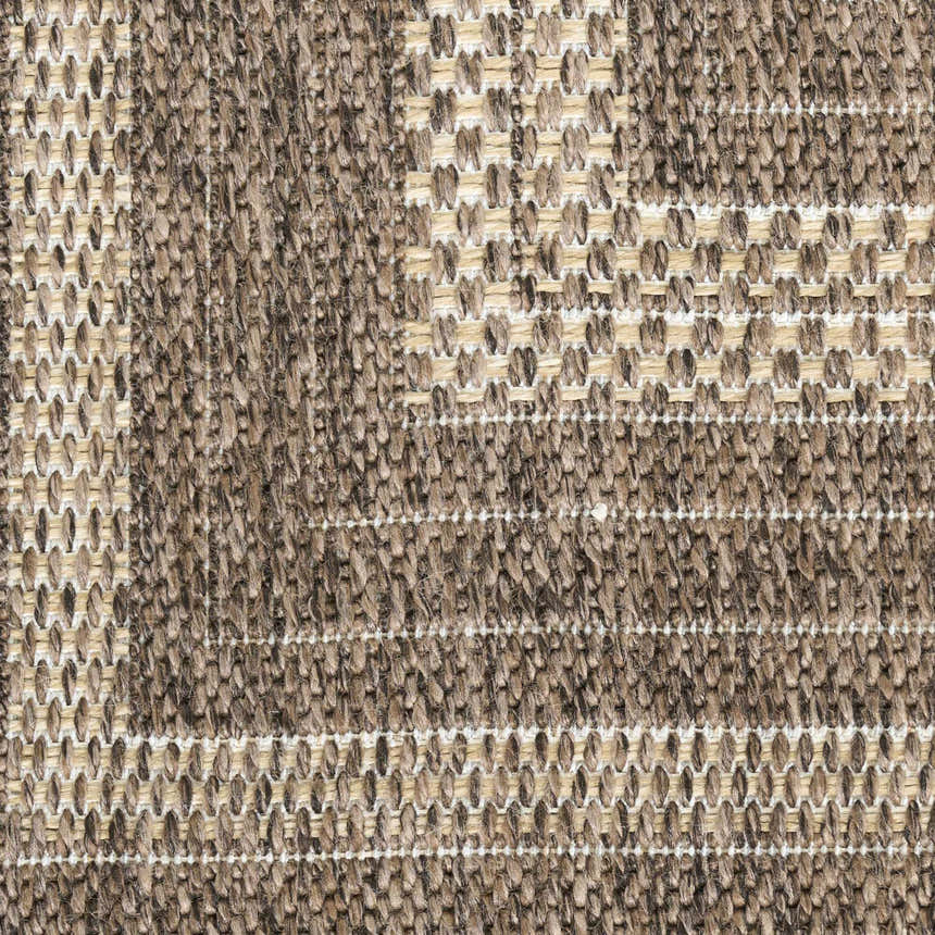 Close-up of Nourison Tulum Brown Outdoor Area Rug showing texture and pattern. Dark brown pile with light tan accents.