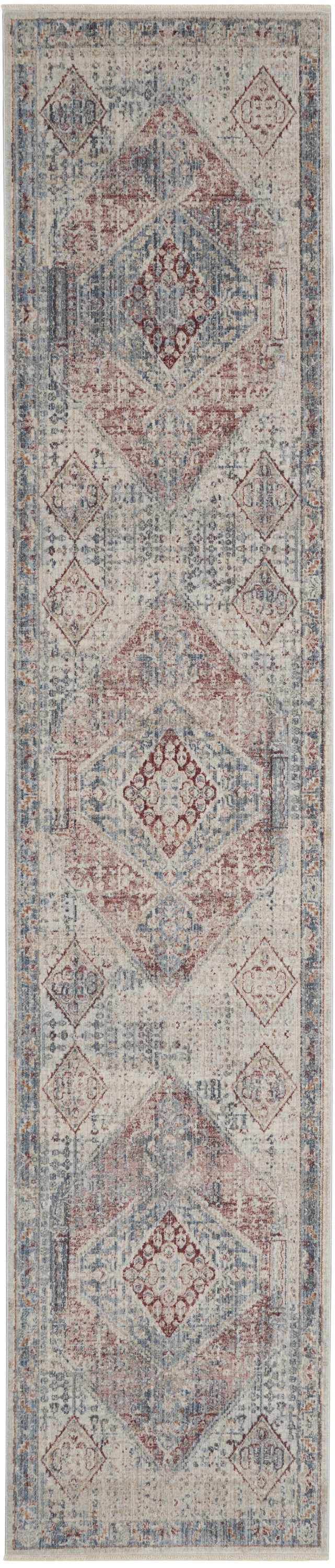 Close-up of Nourison Homestead blue and gray rug. Farmhouse style with geometric diamond pattern and distressed texture.