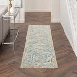 Hallway with Nourison Interlock Blue Multicolor rug, wood floors, console table, and neutral walls.