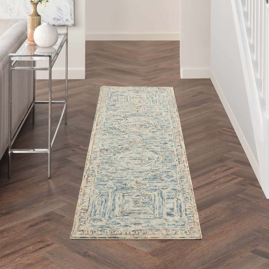 Hallway with Nourison Interlock Blue Multicolor rug, wood floors, console table, and neutral walls.