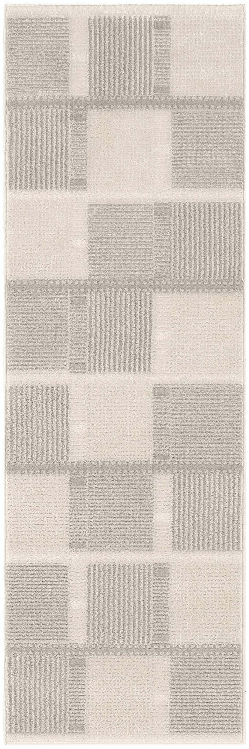 Close-up of Nourison Nordic Ivory Grey rug. Modern design with chestnut accents and a geometric pattern.