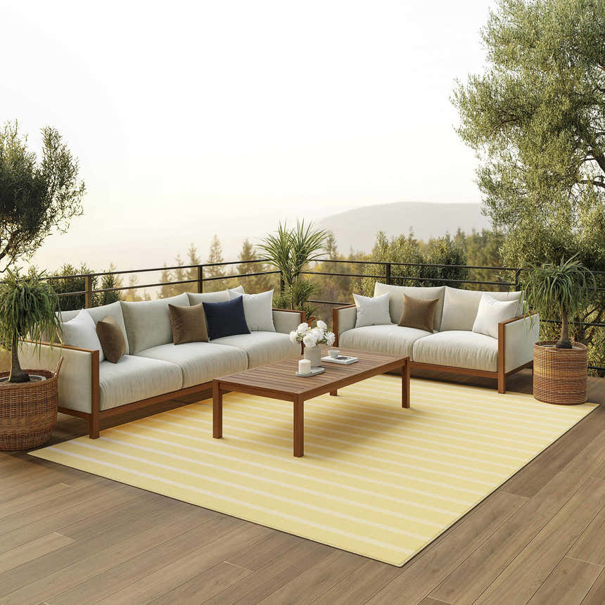 Outdoor patio scene with sofas and Nourison Positano Yellow Ivory rug, creating a modern, inviting space.