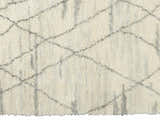 Close-up of the Calvin Klein San Antonio rug. Ivory shag rug with a chestnut Moroccan diamond pattern. Handmade wool texture.