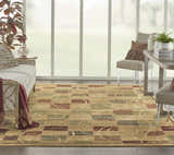 Living room scene with a Nourison Expressions Beige rug, sofa, chairs, and large window. Modern style.