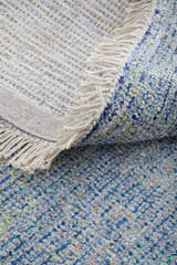 Close-up of the Feizy Caldwell rug in blue and gray, showing texture, weave, and fringe detail. Fold
