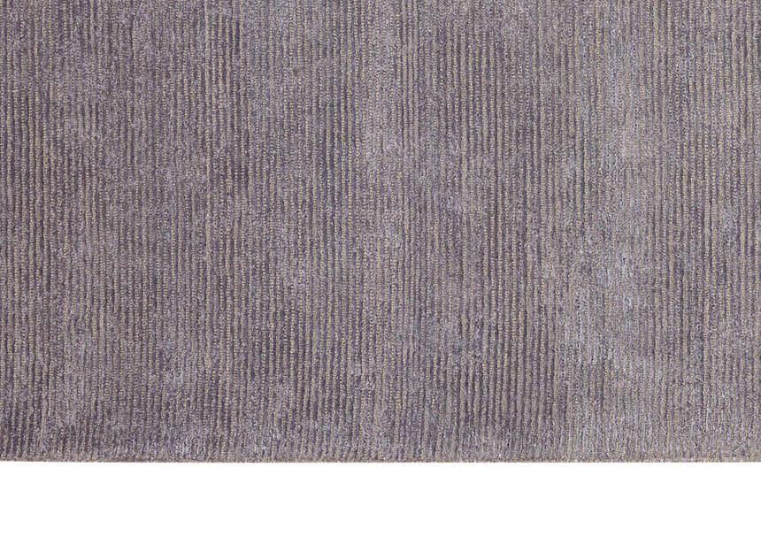 Close-up of the Calvin Klein Home Ravine Nightshade rug, showing a textured, ribbed design in shades of gray and beige.