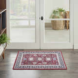 Entryway with Nourison Fulton Red Vintage Indoor Area Rug, wood floors, and white double doors to a patio.