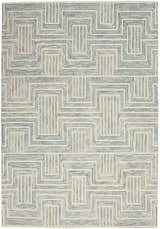 Close-up of the Nourison Interlock Ivory/Turquoise rug. Features a geometric, mid-century modern pattern in shades of blue on an ivory base.