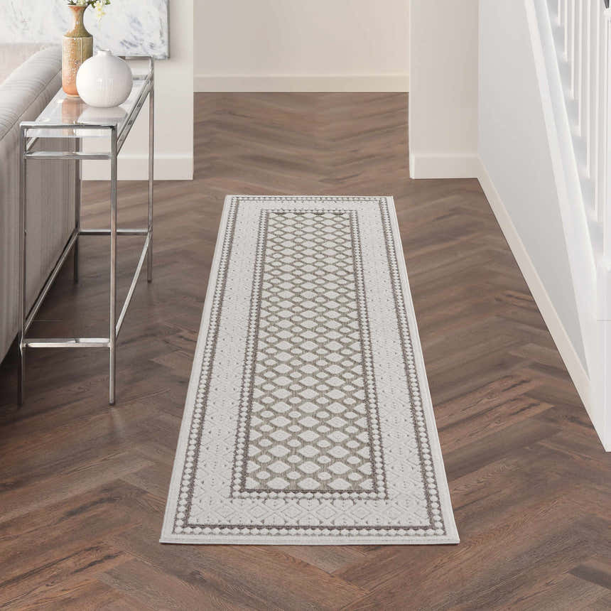 Hallway with Nourison Key Largo Light Grey Transitional Area Rug runner on dark wood floors.