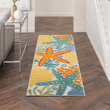 Hallway with Nourison Aloha runner rug. Coastal style with starfish and shells on a herringbone wood floor.