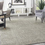 Modern living room with gray armchairs and Nourison Starlight Midnight area rug.