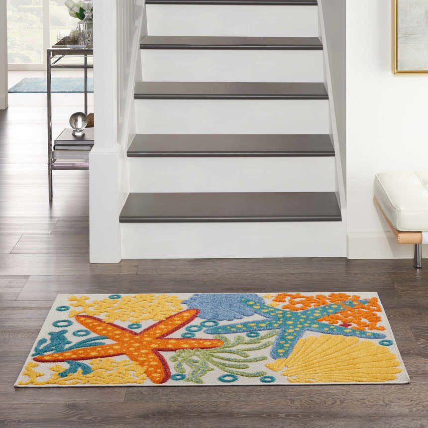 Entryway with Nourison Aloha Multicolor rug featuring starfish and seashells. Coastal decor.