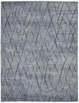 Close-up of the Nourison OCEAN Indigo Rug. Modern, handmade rug with a purple and blue geometric diamond pattern.