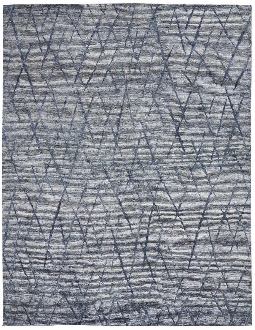 Close-up of the Nourison OCEAN Indigo Rug. Modern, handmade rug with a purple and blue geometric diamond pattern.