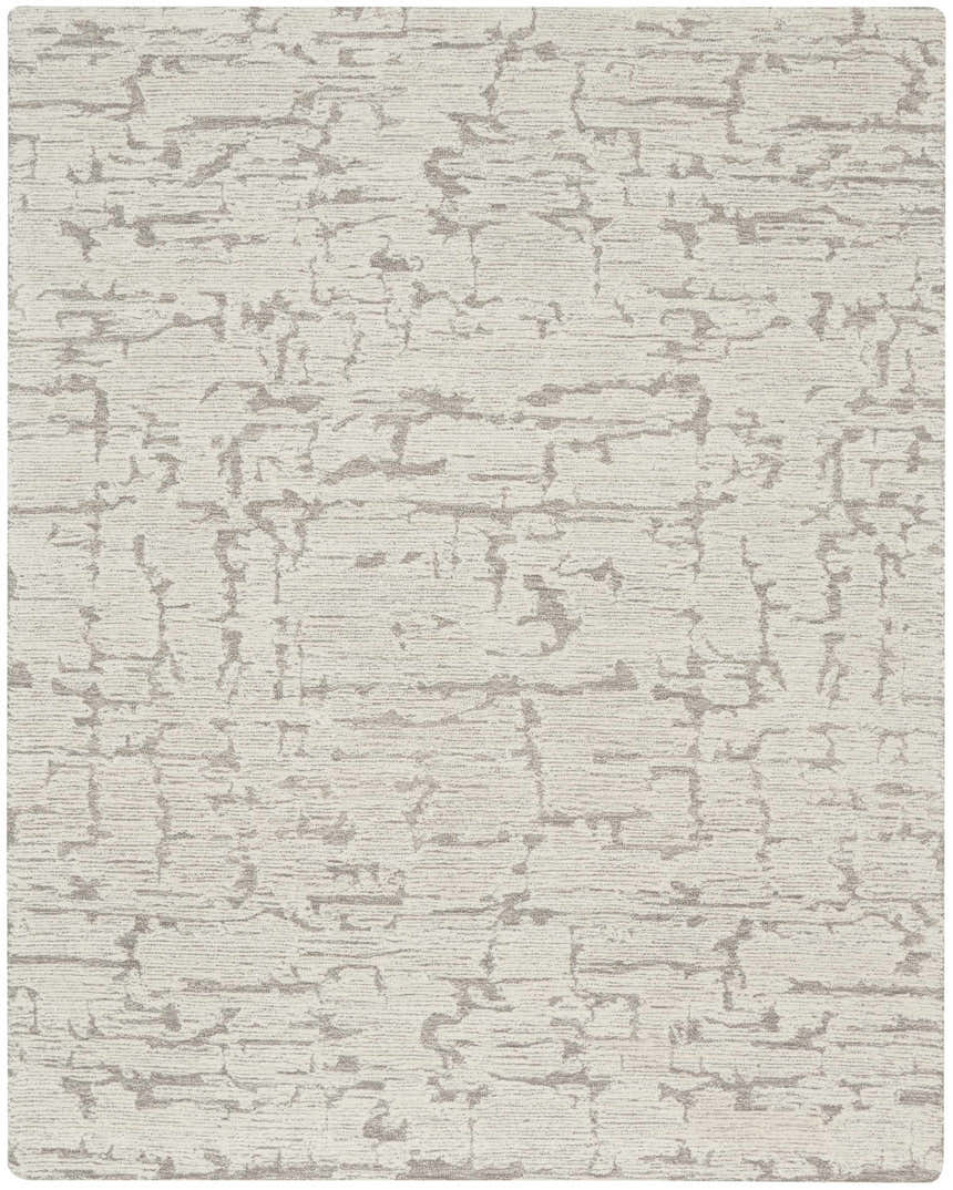 Close-up of the Calvin Klein CK009 Sculptural Grey rug. Handmade wool rug with a modern, abstract pattern and subtle texture.