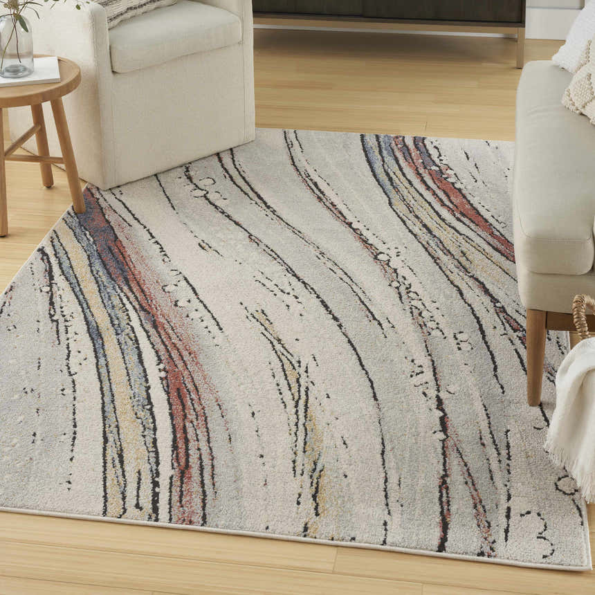 Living room scene with a Nourison Motion Ivory Multicolor rug, cream sofas, and light wood floors.
