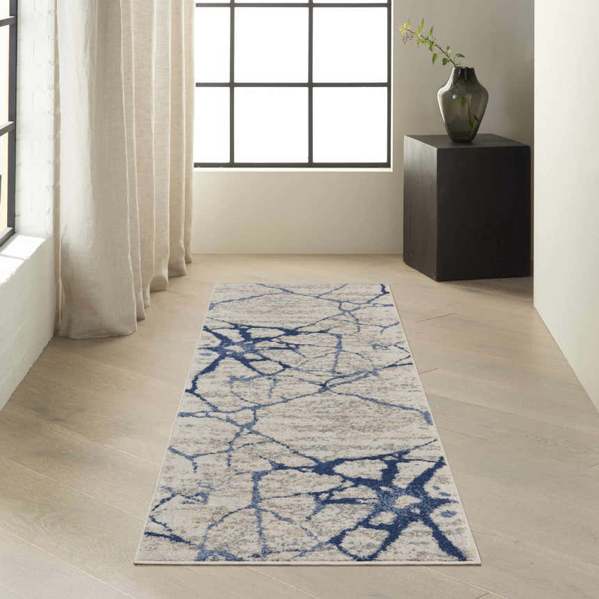 Modern hallway with Calvin Klein River Flow ivory and blue runner rug, wood floors, and natural light.