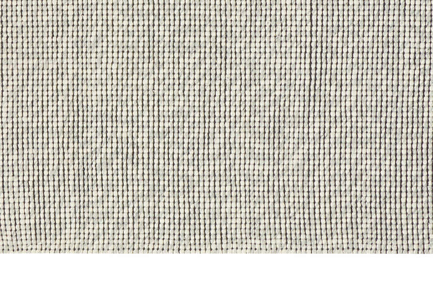 Close-up of Calvin Klein Home Lowland Basalt Rug. Handmade wool rug with a textured, dotted, vertical stripe design.