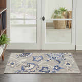 Entryway with Nourison Aloha Blue Grey outdoor rug featuring a floral pattern on a gray background.