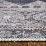 Close-up of Feizy Percy rug showing gray, ivory, and taupe medallion pattern and textured edge on wood floor. Pile